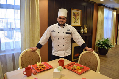 Chef standing by dining table