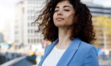 woman practicing mindfulness on a city street