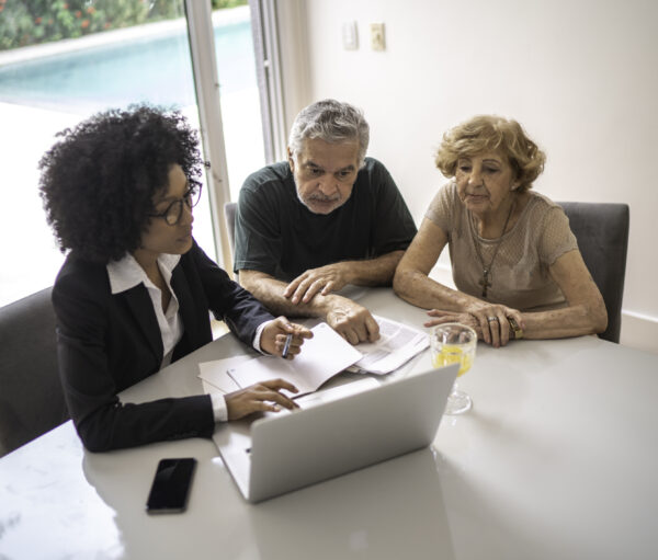 Financial advisor helping a senior couple at home